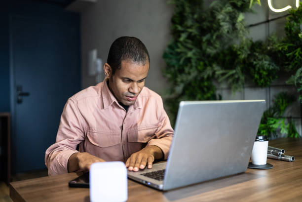 Person working on a laptop in a modern office, representing accessibility testing in practice